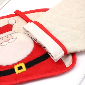 Detail of Christmas oven mitt featuring Santa Claus embroidery and diamond quilting