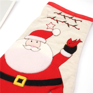 Detail of Christmas stocking with embroidered Santa, bird and star patterns on linen fabric
