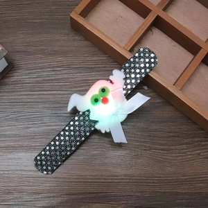 Detail of Halloween LED slap bracelet with white ghost plush on black sequined strap