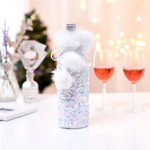 Detail of sequin wine bottle cover with white faux fur collar and plush balls for Christmas