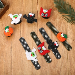Macro detail of Halloween slap bracelets with sequin pumpkin and ghost designs