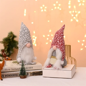 Close-up of plush Christmas gnomes with knitted hats and white beards for holiday decor