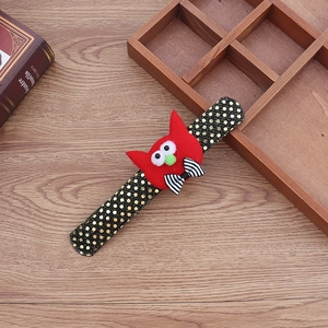 Detail of Halloween slap bracelet with red plush cat character and gold polka dot strap
