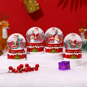 Set of four large Christmas snow globes with Santa and snowman on red festive bases