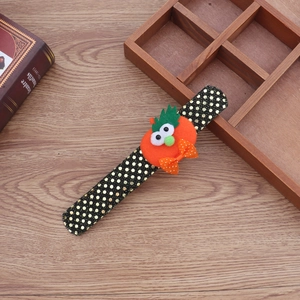 Detail of Halloween slap bracelet with plush orange pumpkin and gold polka dot fabric