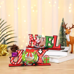 Detail of JOY and NOEL wooden Christmas table decorations with festive letter patterns