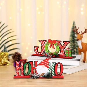 Close-up of JOY and HO HO HO wooden Christmas tabletop ornaments with gnome motifs