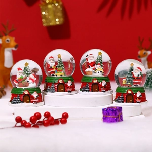 Detailed set of four Christmas snow globes with Santa Claus and festive red house bases