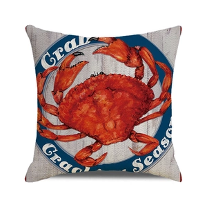 Detailed close-up of a square decorative pillow with red crab print and Crab Season text