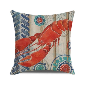 Detail of nautical cushion cover with red lobster illustration and geometric patterns