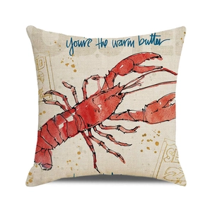 Detail of linen pillowcase featuring red lobster print and warm butter typography