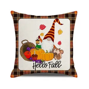Close-up of Hello Fall gnome pumpkin cushion cover with orange and black plaid trim