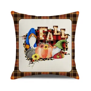 Detail of fall gnome pumpkin pillow cover with plaid border and linen texture finish