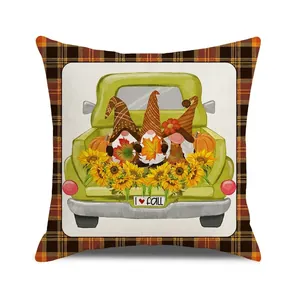 Detailed view of fall gnome pumpkin cushion cover with plaid edge and green pickup truck