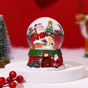 Detailed Christmas snow globe featuring Santa and snowman with a festive house base