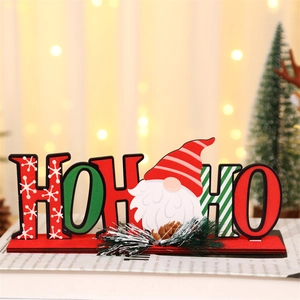 Detailed view of HO HO HO Christmas wooden sign with gnome and festive pine decorations
