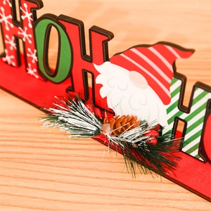 Detail of Christmas HOHO wooden tabletop decor with pine cones and berries