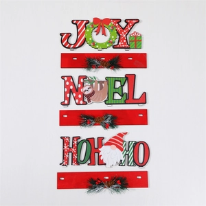 Detailed view of wood Christmas JOY NOEL letter ornaments with Santa and pine cone decor