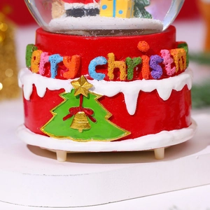 Detailed relief of Merry Christmas lettering on a red musical snow globe base