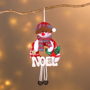 Close-up of a Christmas wreath featuring a plush snowman, NOEL wood sign, and metal bells