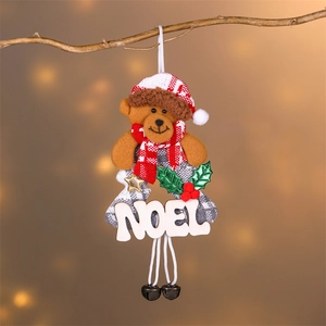 Christmas teddy bear ornament with Noel wooden sign and bells on festive tree branch
