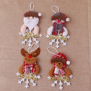 Close-up of plush Santa and Snowman ornaments with white snowflake base on jute background