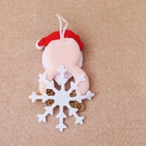 Close-up of reindeer felt pendant with white snowflake and Merry Christmas gold lettering