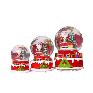 Three sizes of musical Christmas snow globes with Santa Claus and red Merry Christmas bases
