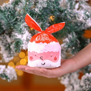 Close-up of a Santa Claus gift bag with red rabbit ears held in hand for scale