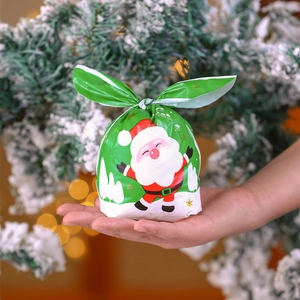 Christmas gift bag with Santa Claus design and bunny ear ties for candy and treats