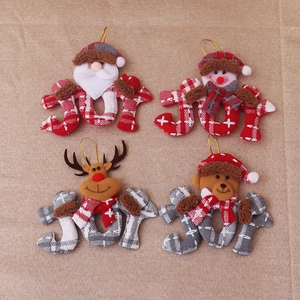 Detailed view of four JOY Christmas plush ornaments featuring Santa and snowman figures