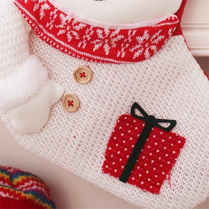 Detail of red and white knit Christmas stocking with snowflakes and wooden buttons