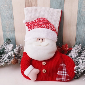 Detailed close-up of knitted red Santa stocking with wooden buttons and white waffle cuff