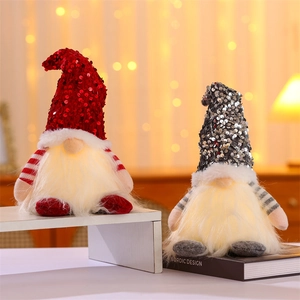 Close-up of red and grey glowing Christmas gnomes with sequined hats and warm LED lights