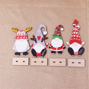 Set of four wooden Christmas gnomes with festive patterns on a rustic linen background
