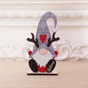 Detailed view of a wooden Christmas gnome with reindeer antlers and Welcome sign base