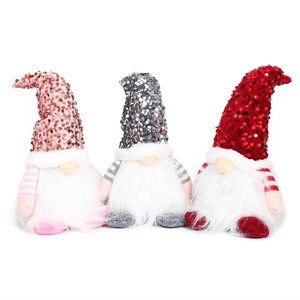 Three glowing Christmas gnomes with sequin hats and long white beards on white background