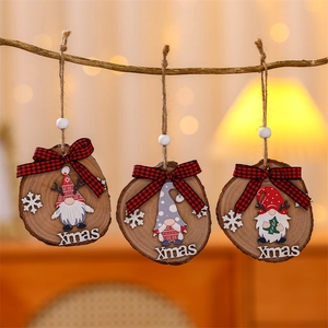 Close-up of three wooden Christmas gnomes with Xmas text and red plaid bows