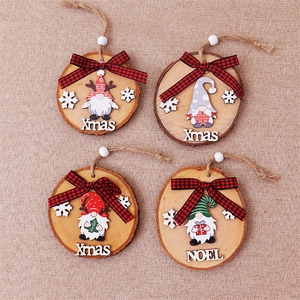 Close-up of four rustic Christmas gnomes on natural wood slices with Xmas and Noel text
