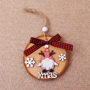 Detail view of round wooden Christmas gnome ornament with red plaid bow and Xmas text