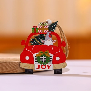 Detail view of a red wooden car ornament with a gnome, Christmas tree, and JOY wreath