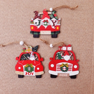 Three wooden Christmas car pendants with gnomes and rustic twine on burlap background