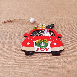 Detail of red wooden car ornament with Xmas tree, gift box and festive gnome