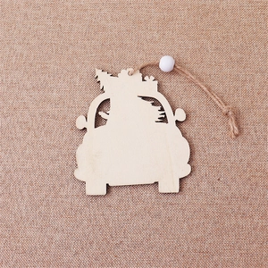 Close-up of laser-cut wooden car Christmas tree ornament with jute rope and white bead