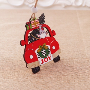 Macro detail of wooden Christmas car pendant with gnome and JOY text on rustic fabric