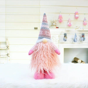 Pink Nordic Christmas gnome with long beard and snowflake knit hat by a warm fireplace