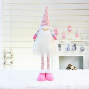 Detailed view of pink Christmas gnome plush with striped legs on a soft white rug