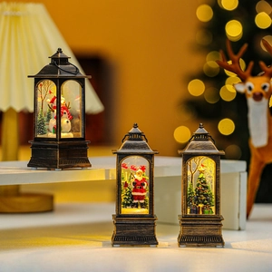 Close-up of vintage bronze Christmas lanterns with glowing snowman and Santa scenes