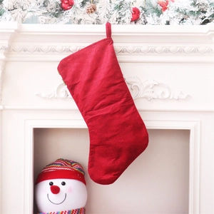 Detail of red fleece Christmas stocking with hanging loop on a white fireplace mantle
