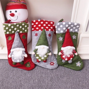 Detailed view of large Christmas stockings with 3D gnome design and snowflake embroidery